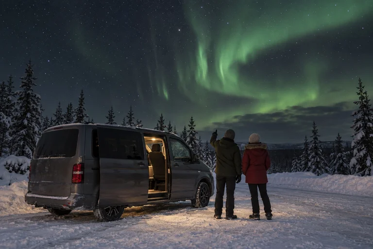 Generated illustration of travellers watching northern lights beside a parked minivan